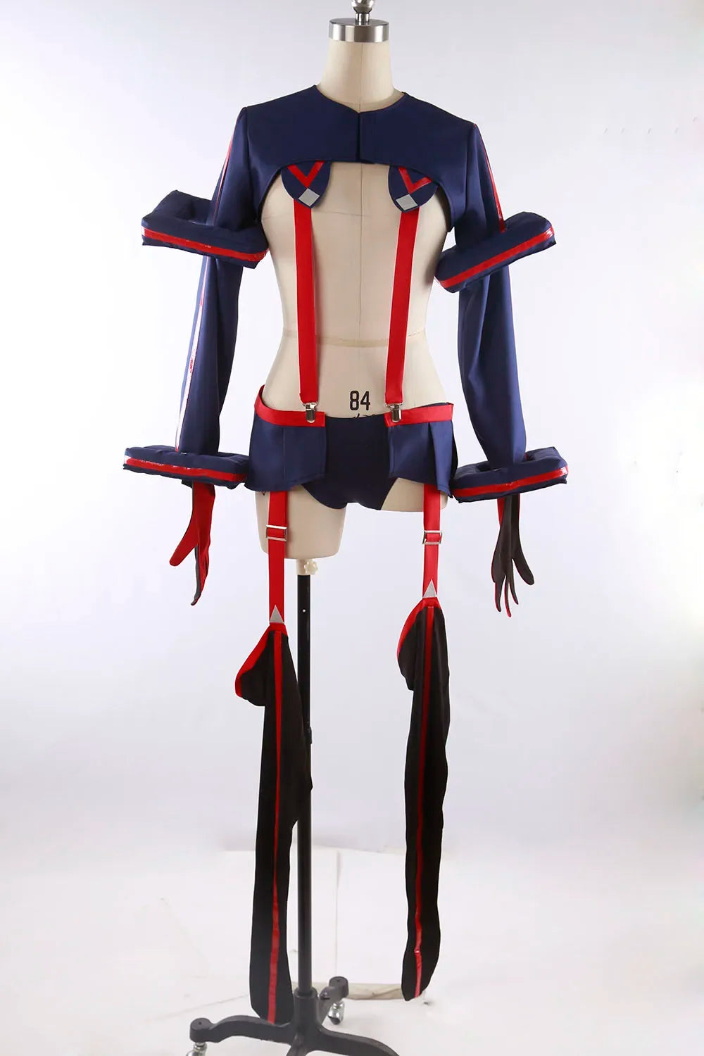 Cosplay costume on mannequin, front view: navy top with red trim, red suspenders, black leg wraps