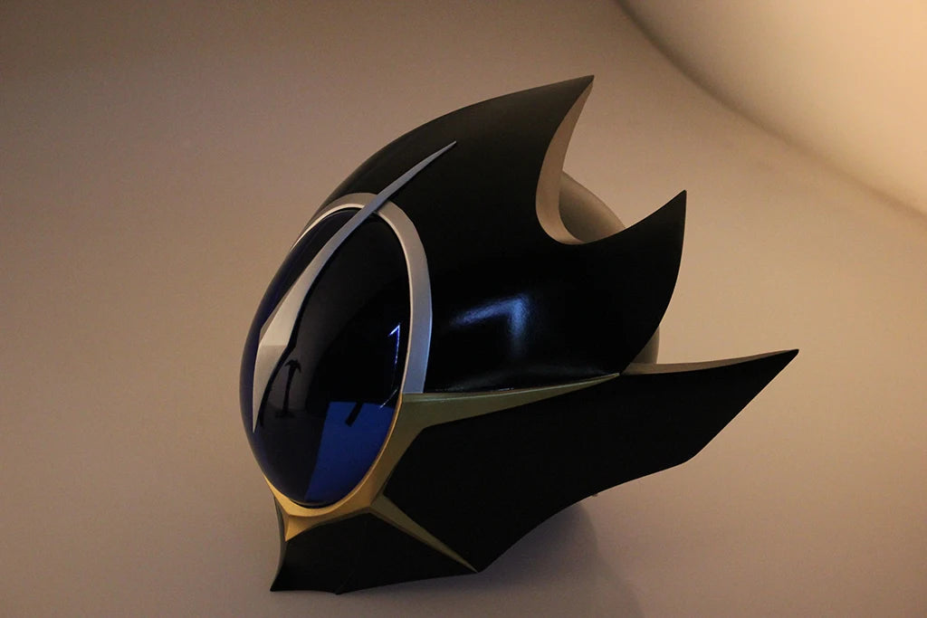 Black cosplay helmet with blue visor, silver center fin, and gold edge details