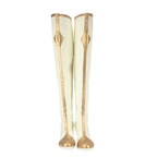 Pair of knee-high white boots with gold trim and pointed metallic toe details